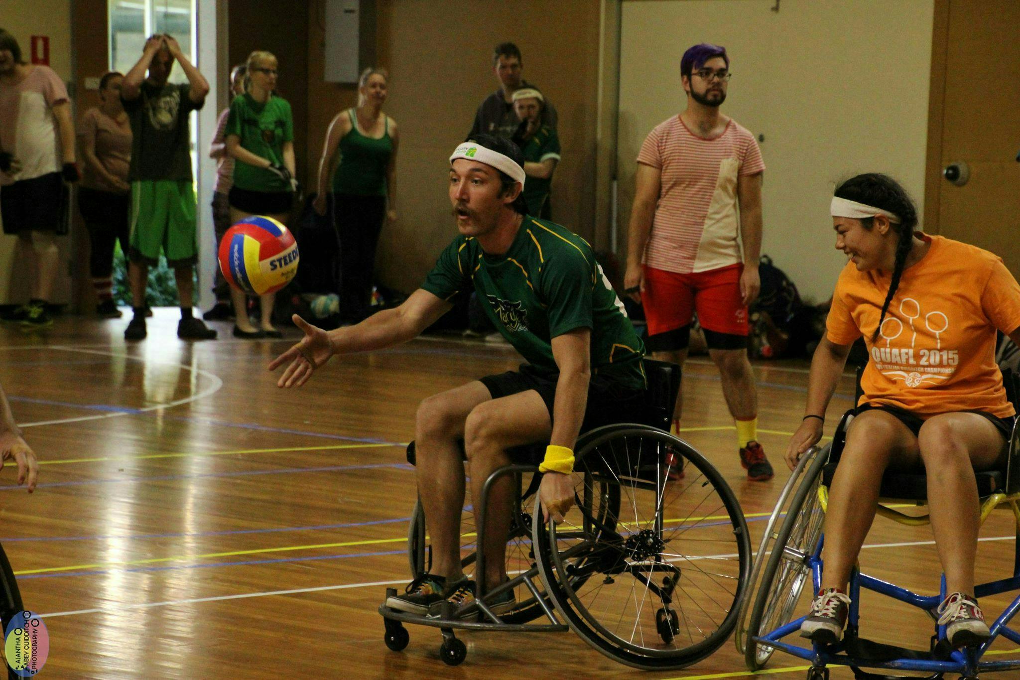 Player throws the ball while playing Wheelchair Quadball