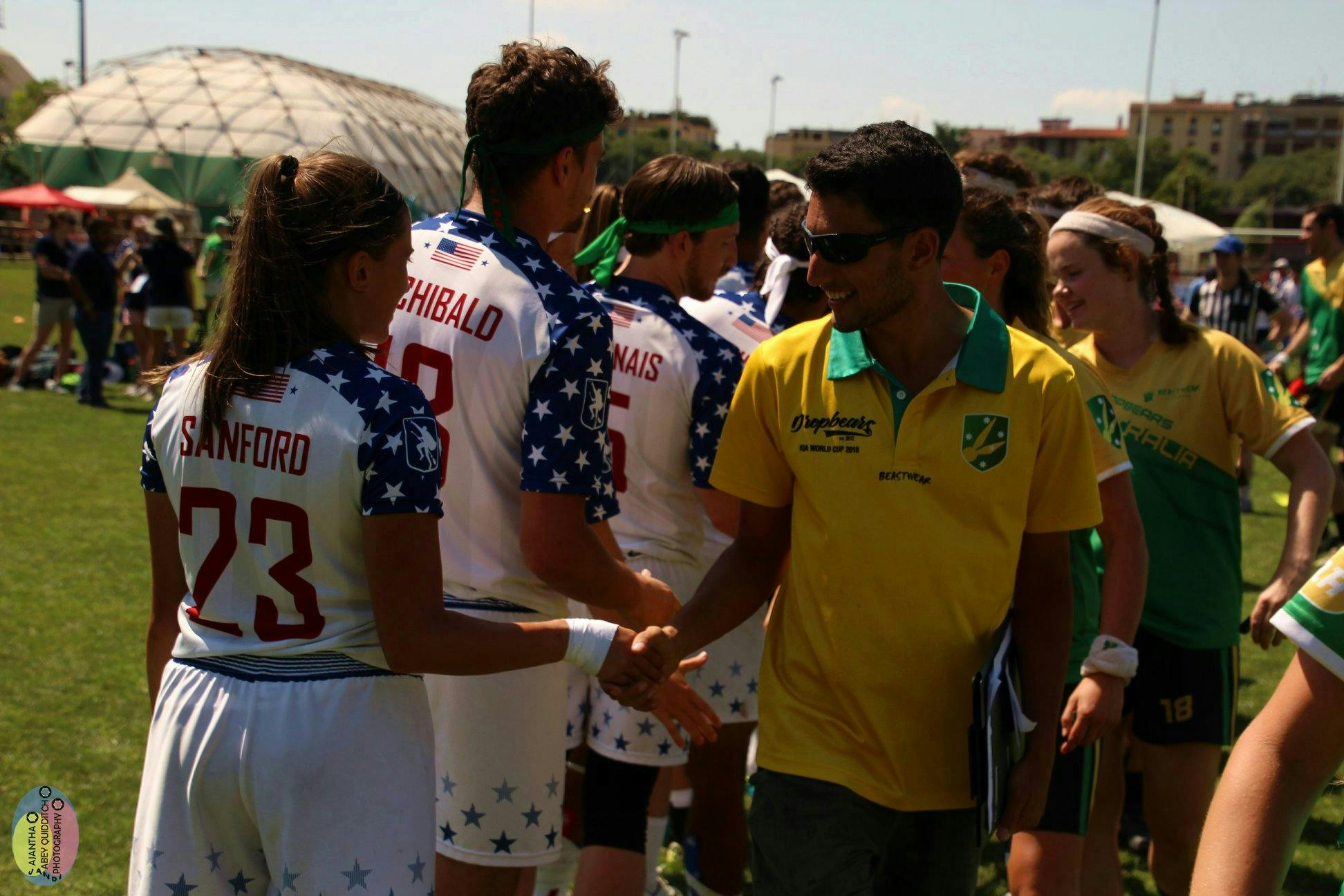 Players and staff shake hands before a match 