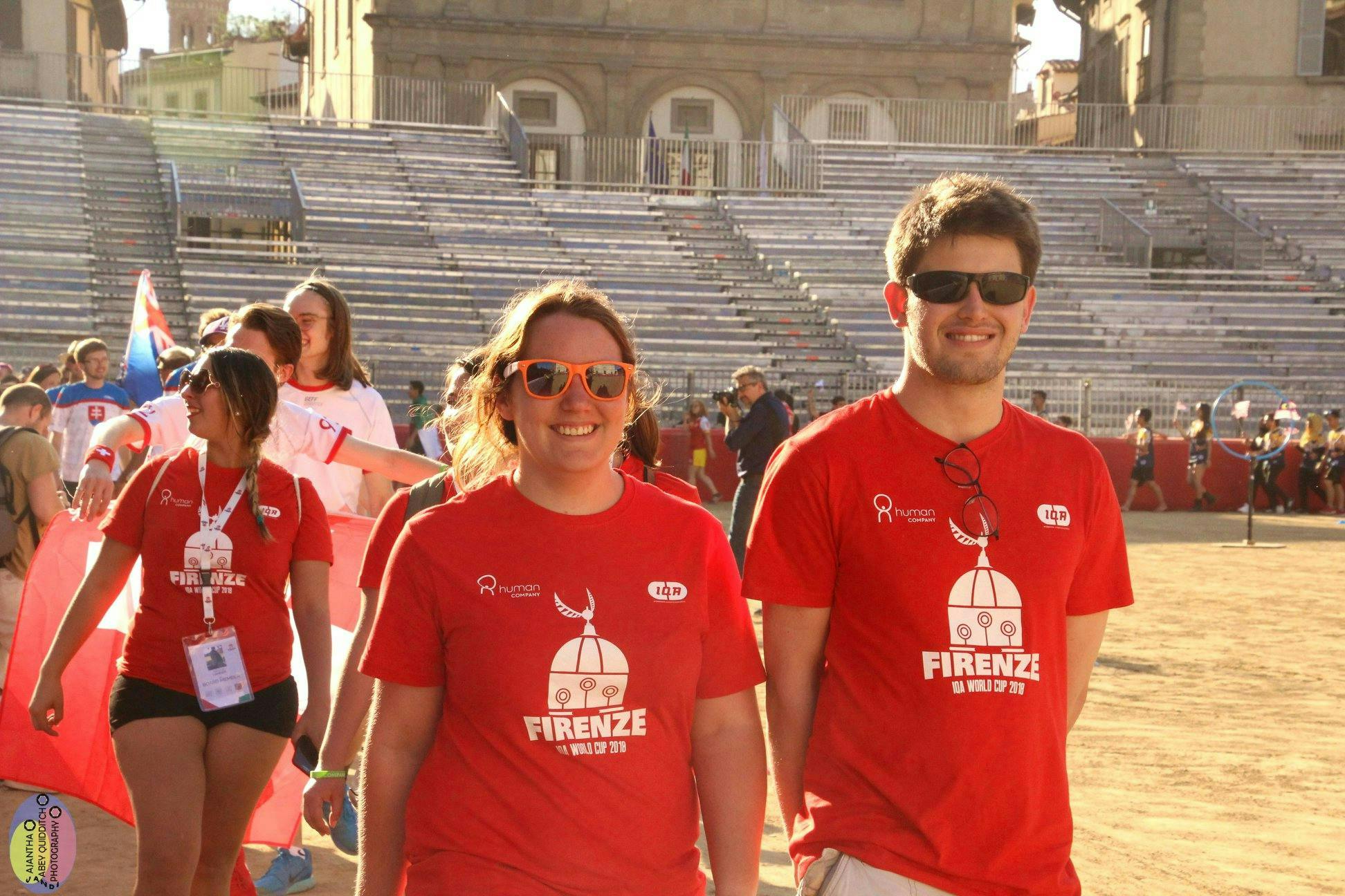 Two volunteers standing side by side, smiling 